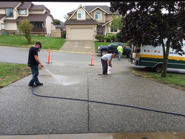 spraying new aggregate concrete driveway